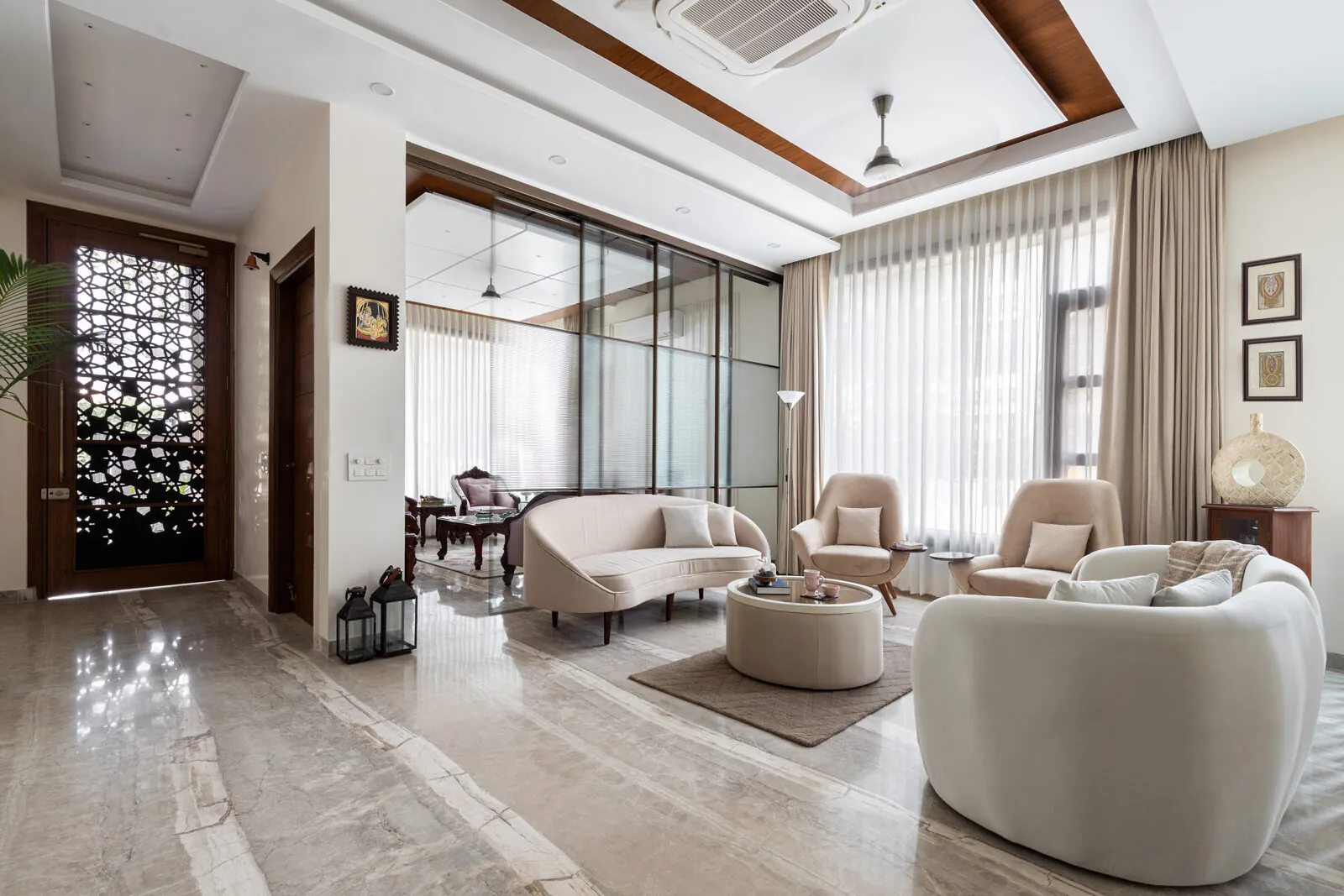 Light-filled contemporary living room by AKS Architecture Studio